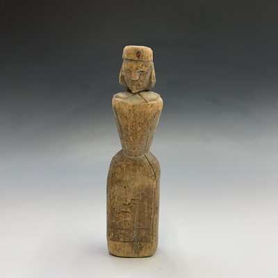 Lot 670 - A primitive folk art carved wooden doll or...