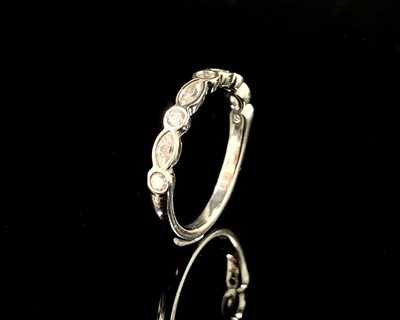 Lot 746 - A platinum half-eternity ring set with...