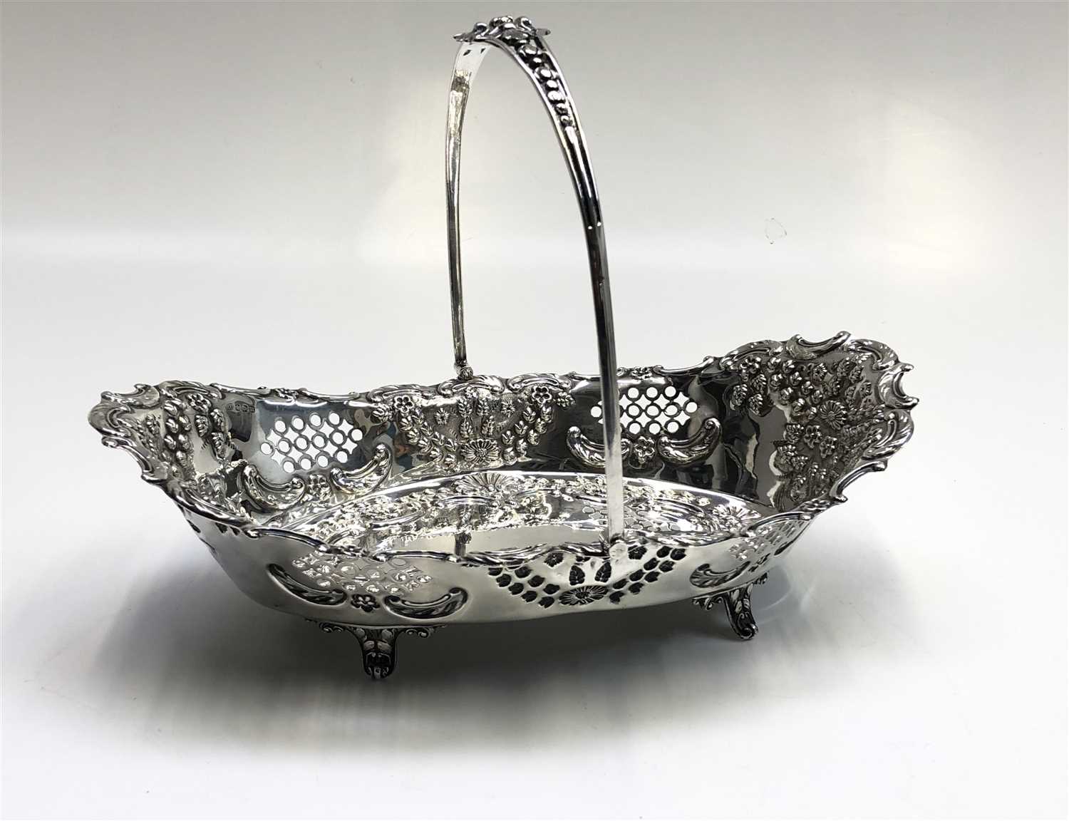 Lot 2094 - A silver swing handle fruit basket with ornate...