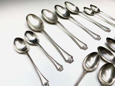 Lot 72 - A set of twelve beaded silver teaspoons and...