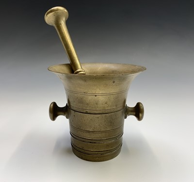 Lot 699 - A 19th century brass mortar and pestle. Height...