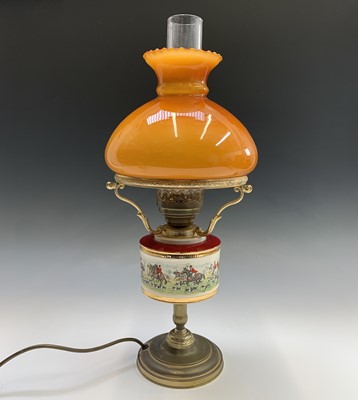 Lot 258 - A brass effect oil lamp, the ceramic reservoir...