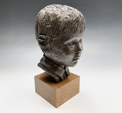 Lot 698 - A bronzed head of boy, signed Judy Boot, on...