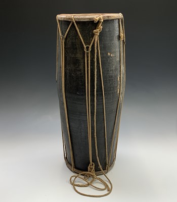 Lot 701 - An ethnic barrel drum with black lacquered...