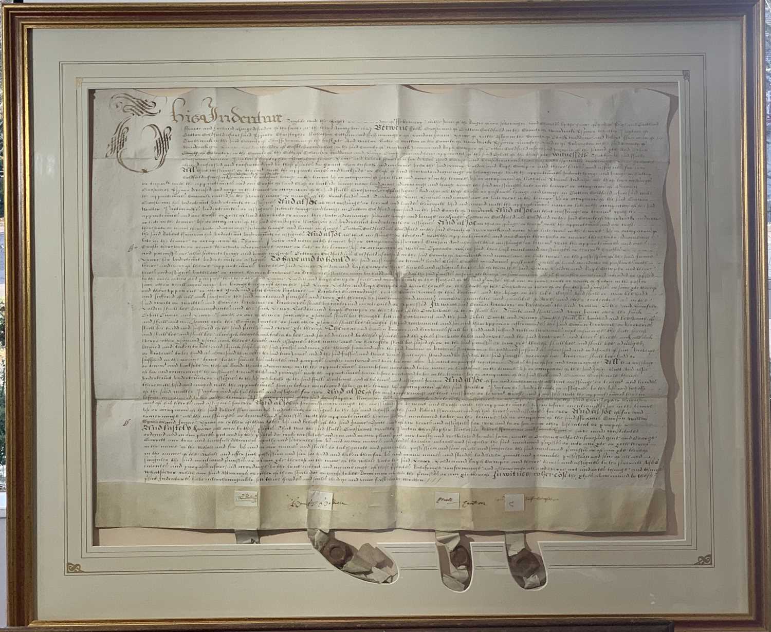 Lot 1555 - An indenture on vellum with three attached...