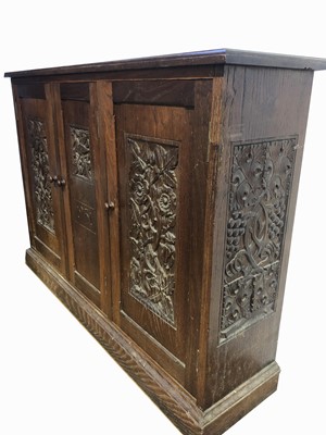 Lot 1804 - An Arts and Crafts oak cupboard, dated 1931,...