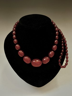 Lot 331 - A 'Cherry Amber' necklace, 69gm.