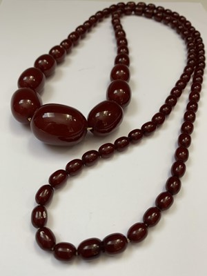 Lot 331 - A 'Cherry Amber' necklace, 69gm.