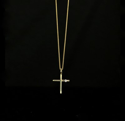 Lot 558 - An 18ct gold cross set a diamond on 18ct gold...