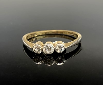 Lot 572 - An 18ct gold three stone diamond ring.