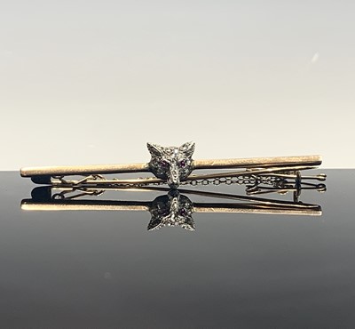 Lot 524 - A gold bar brooch, mounted with a diamond pave...