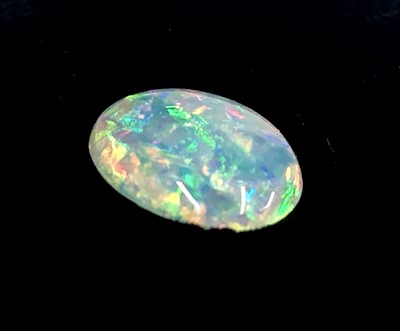 Lot 363 - An unmounted oval opal weighing 1.29 cts, 8mm...