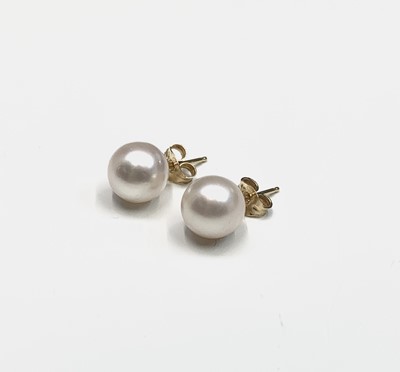 Lot 737 - A pair of gold mounted pearl earrings, each...