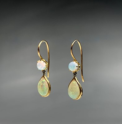 Lot 476 - A pair of opal earrings set in gold. Purchased...