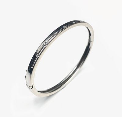 Lot 312 - A contemporary 18ct white gold hinged bangle...
