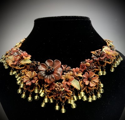 Lot 685 - An ornate "amber" flower and bead necklace