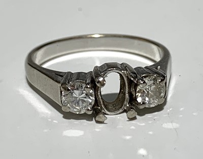 Lot 580 - An 18ct white gold ring set with two diamonds...