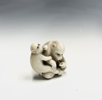 Lot 6 - A Japanese ivory netsuke of a monkey with her...