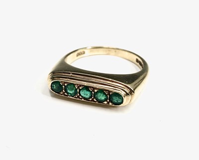 Lot 593 - A stylish 18ct gold five stone emerald ring...