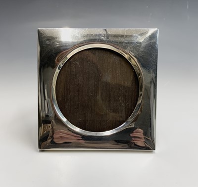 Lot 18 - A square photo frame with wide silver border...