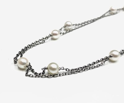 Lot 353 - A platinum long chain with pearls spaced out...