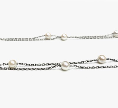 Lot 353 - A platinum long chain with pearls spaced out...