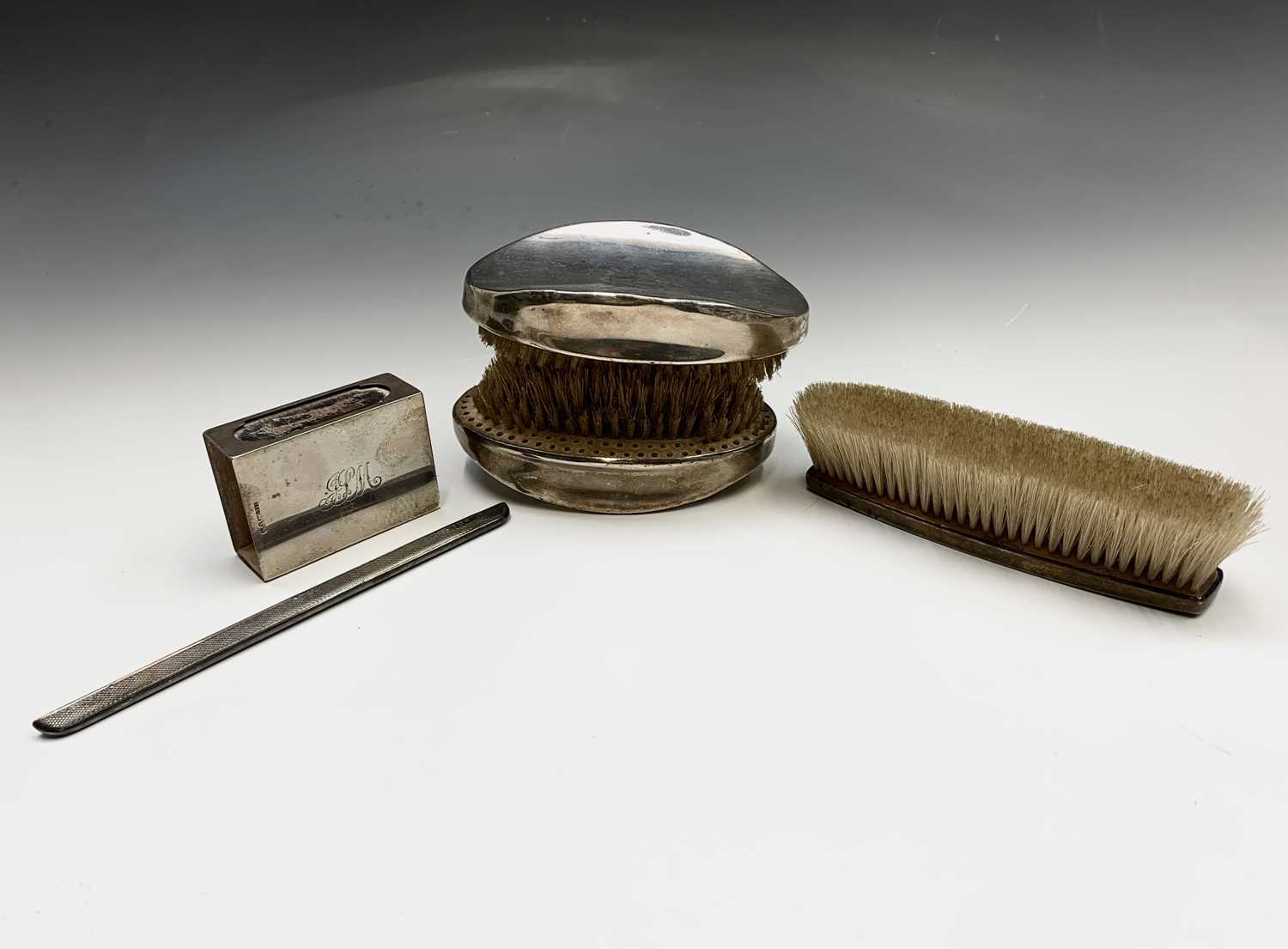 Lot 49 - A pair of heavy silver-mounted brushes one...