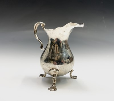 Lot 59 - A Georgian silver bellied crested cream jug...