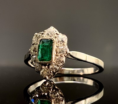 Lot 351 - An emerald and diamond cluster ring of pear shape