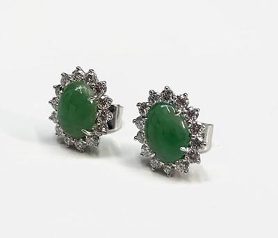 Lot 306 - A pair of fine green jade and diamond oval...