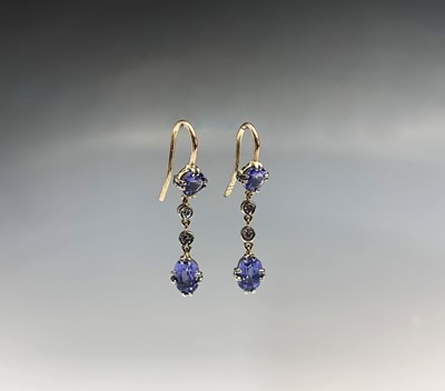 Lot 714 - A pair of tanzanite and diamond drop earrings