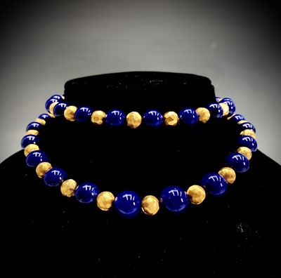 Lot 316 - A lapis lazuli and gold bead necklace, 103.6g.