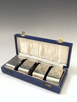 Lot 106 - A set of four silver napkin rings with the...