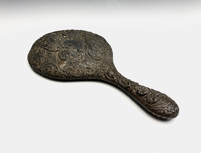 Lot 115 - A silver-mounted hand mirror. Worn