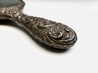 Lot 115 - A silver-mounted hand mirror. Worn