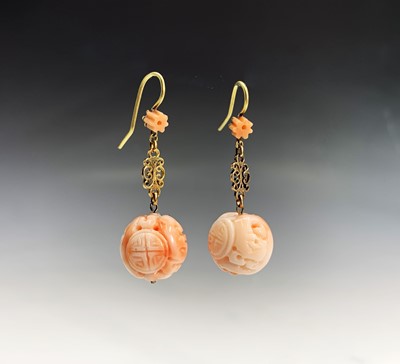 Lot 385 - A pair of Chinese carved pink coral sphere...