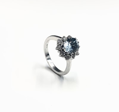 Lot 529 - A cluster ring with an aquamarine of 1.34cts...