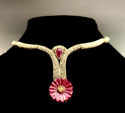 Lot 747 - A diamond set necklace with carved pink ruby...