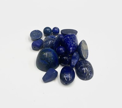 Lot 458 - Various lapis lazuli beads and cabochons, 148.7g.