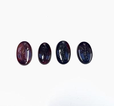 Lot 485 - Four carved agate intaglios, approximately 32cts.