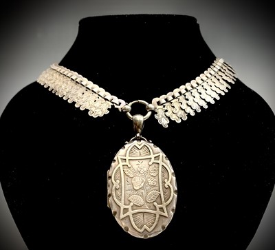 Lot 595 - A Victorian Aesthetic Movement silver locket...