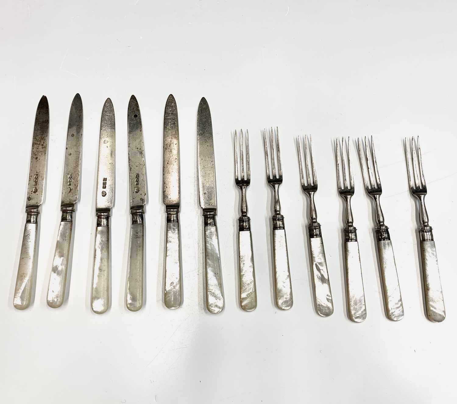 Lot 19 - A set of six dessert knives and forks by...