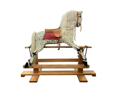 Lot 240 - A dapple grey rocking horse on pine stand,...