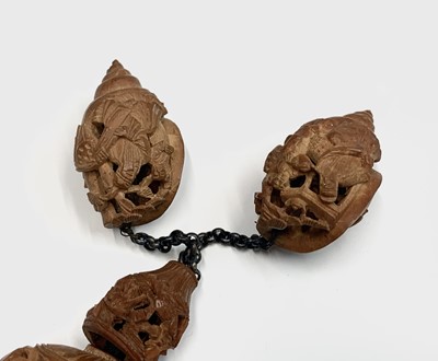 Lot 89 - A Chinese carved coquilla nut necklace