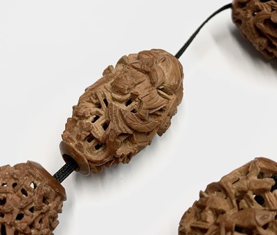 Lot 89 - A Chinese carved coquilla nut necklace