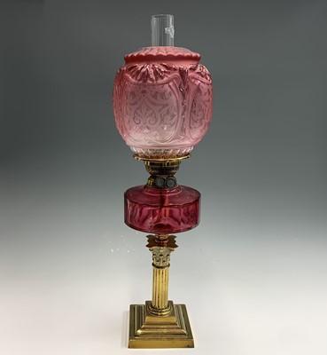 Lot 5 - A late Victorian cranberry glass and brass oil...