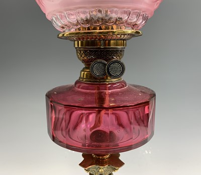 Lot 5 - A late Victorian cranberry glass and brass oil...