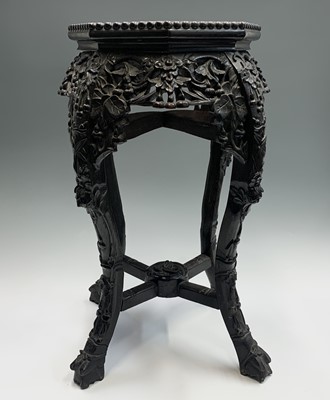 Lot 85 - A Chinese carved hardwood jardiniere stand,...