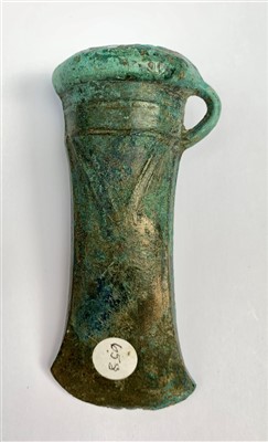 Lot 454 - Bronze Age decorated and looped axe head,...