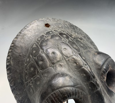 Lot 64 - A painted wall hanging tribal mask, with...